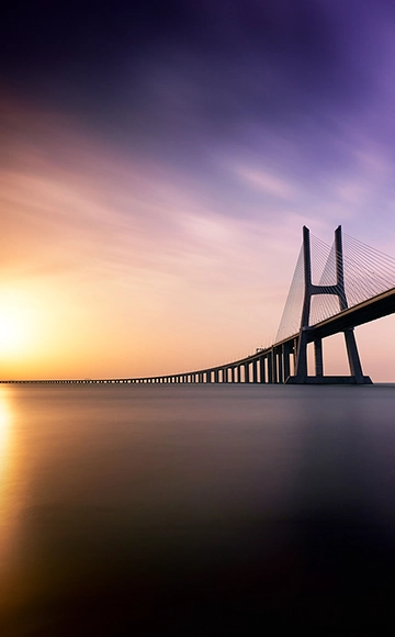 Bridge across the water at dawn